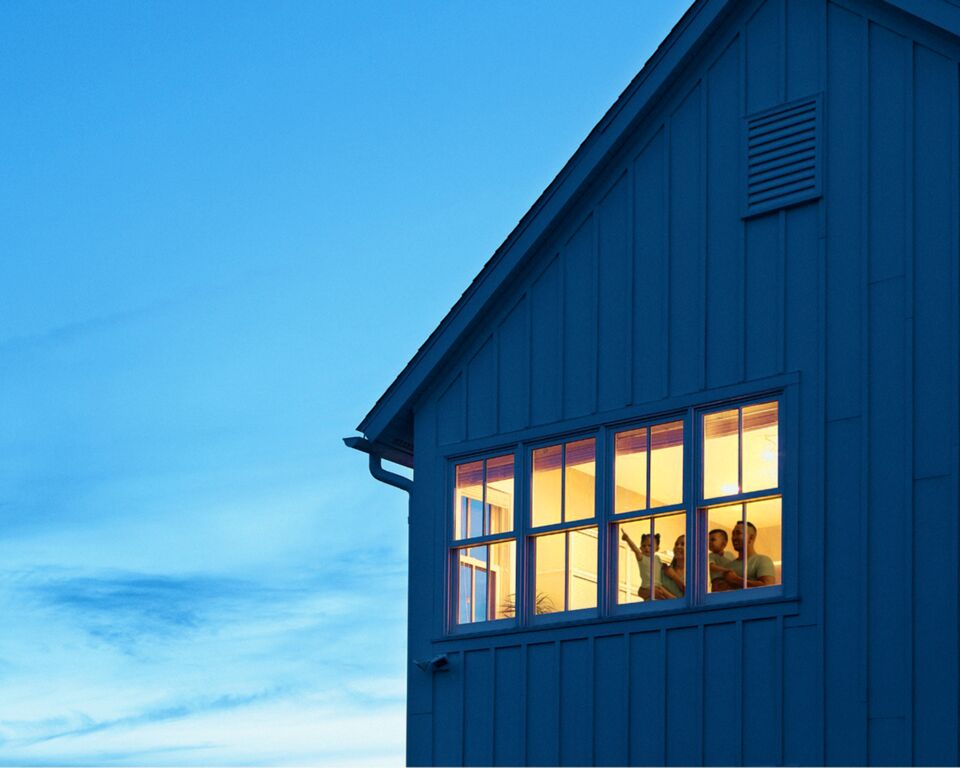 Family enjoying their improved home at dusk