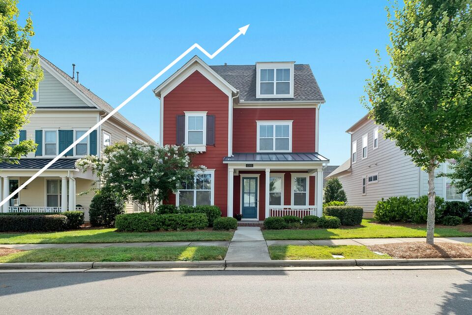 Red house beneath an upward-trending arrow