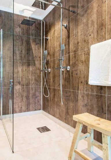 Rustic wood-paneled walk-in shower