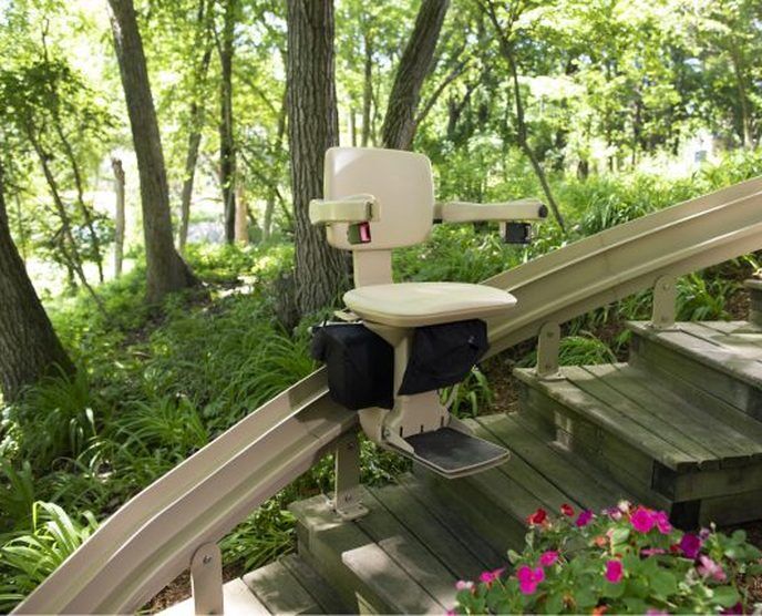 Outdoor stairlift on wooden deck steps