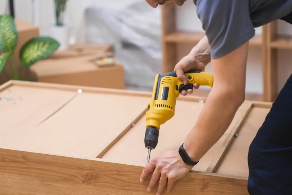 Handyman installing cabinetry