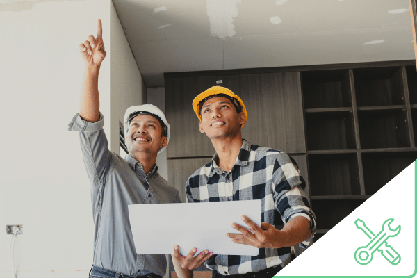 Construction worker working on bathroom tub plumbing