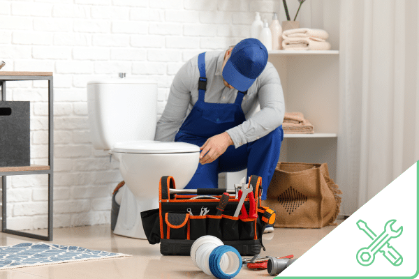 Construction worker working on toilet